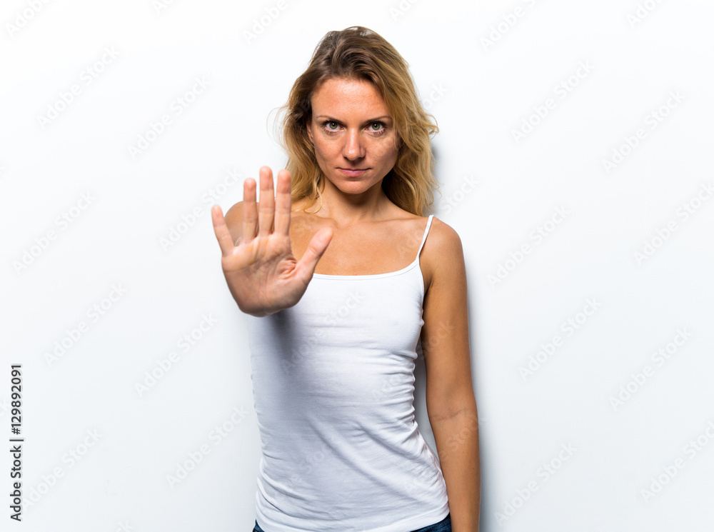 Pretty young woman making stop sign Pretty young woman making stop sign