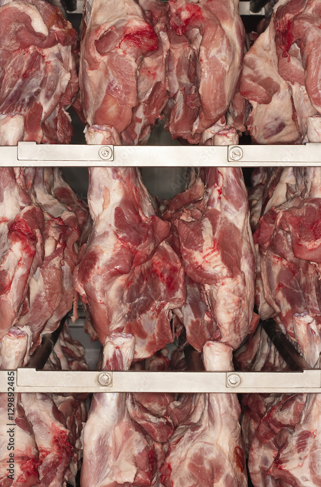 Closeup of raw meat hanging on rack