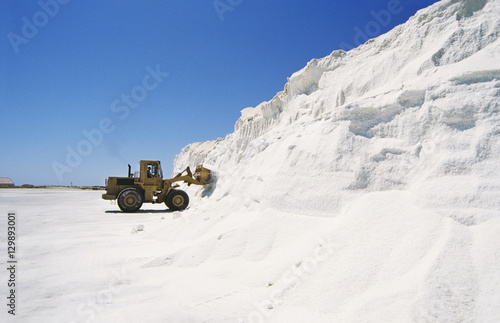 Bulldozer truck loading salt at refining plant © moodboard