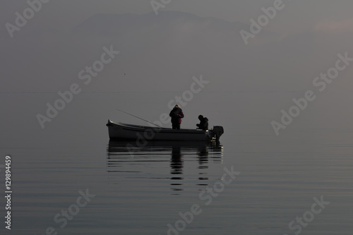 boat with fishermen in winter fog