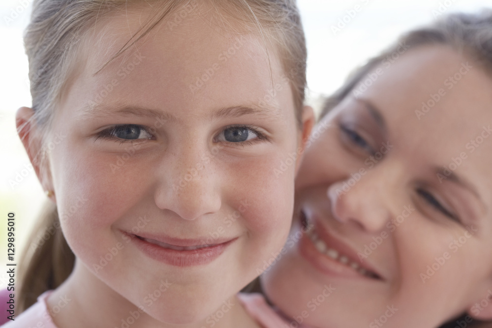 Closeup portrait of cute young girl with loving mother Closeup portrait of cute young girl with loving mother