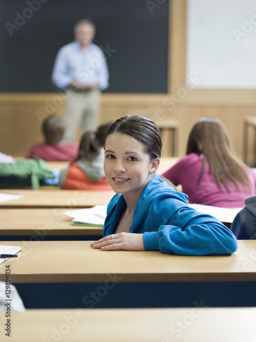 Portrait of a female in lecture room with blurred students