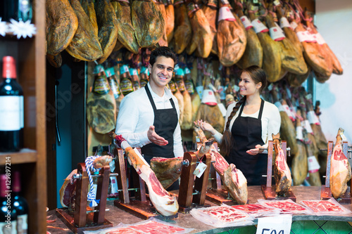 Two workers selling jamon