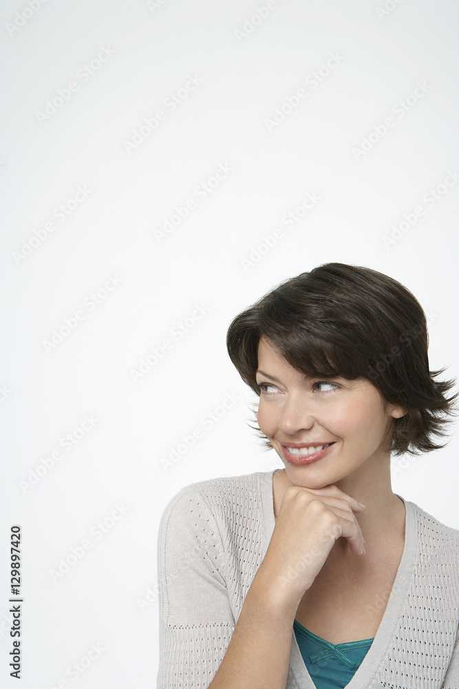 Pretty woman looking sideways with hand on chin isolated on white background Pretty woman looking sideways with hand on chin isolated on white background