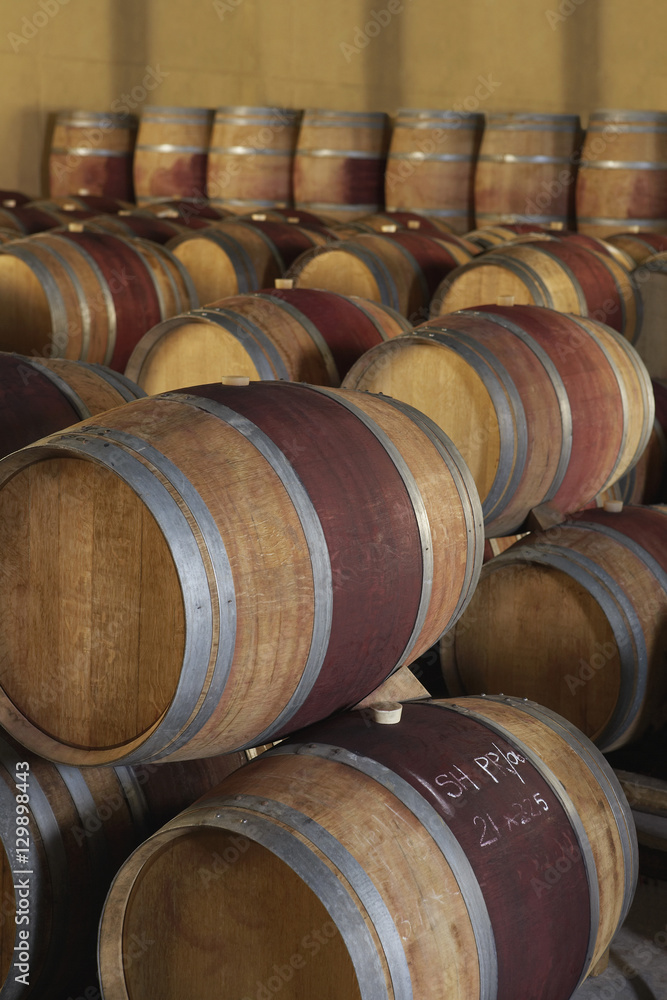 Stacked wine barrels to ferment in cellar
