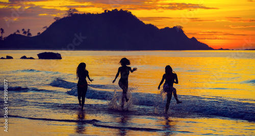 Silhouette of  girls at sunset in the background of the Philippine Islands