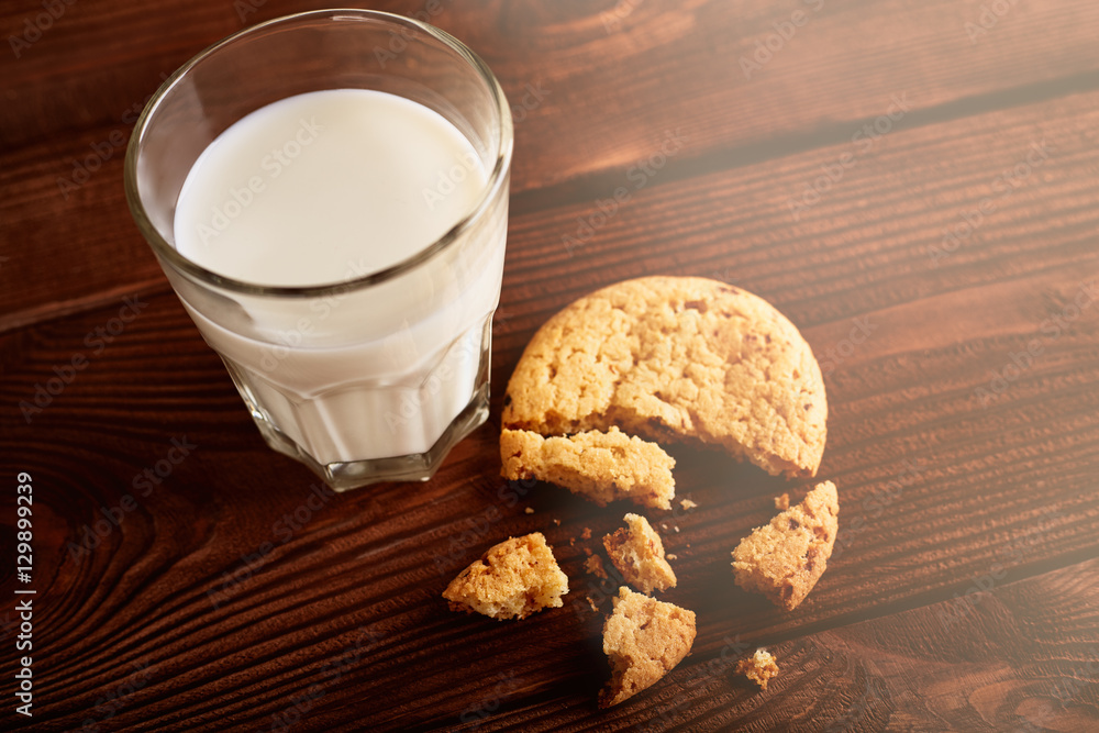 Cookies and milk. Chocolate chip cookies and a glass of milk. Vintage look. Tasty cookies and glass of milk on rustic wooden background. Food, junk-food, culinary, baking and eating concept Cookies and milk. Chocolate chip cookies and a glass of milk. Vintage look. Tasty cookies and glass of milk on rustic wooden background. Food, junk-food, culinary, baking and eating concept