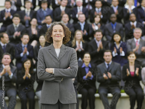 Portrait of a businesswoman in front of blurred multiethnic businesspeople