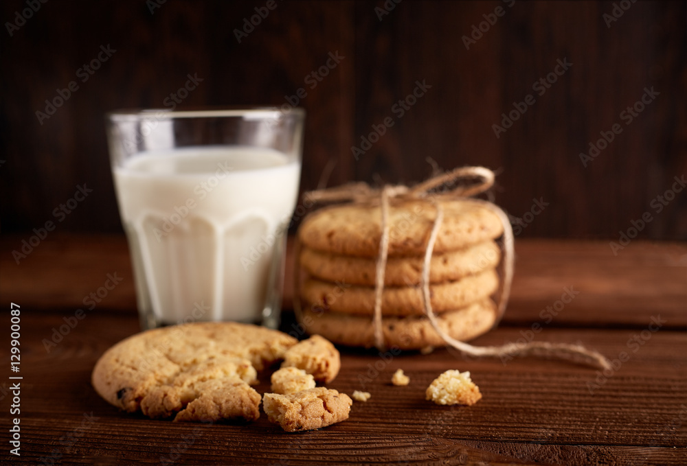 Cookies and milk. Chocolate chip cookies and a glass of milk. Vintage look. Tasty cookies and glass of milk on rustic wooden background. Food, junk-food, culinary, baking and eating concept Cookies and milk. Chocolate chip cookies and a glass of milk. Vintage look. Tasty cookies and glass of milk on rustic wooden background. Food, junk-food, culinary, baking and eating concept