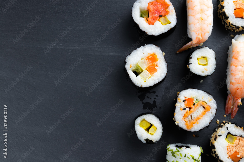 Typical asian cuisine set on black kitchen slate plate. Typical asian cuisine set on black kitchen slate plate.