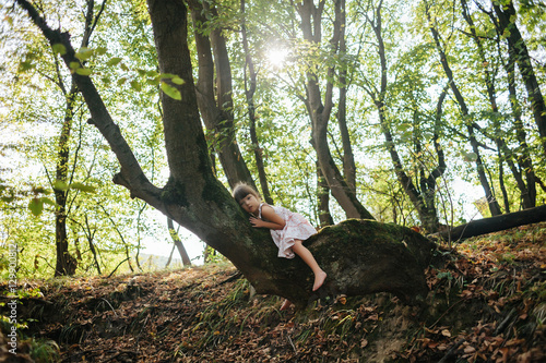 child hugged a tree. listen to the trees