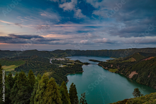 Mountain landscape in green valley with green lake in Azores island mountains with beautiful clouds at sunset time © willyam