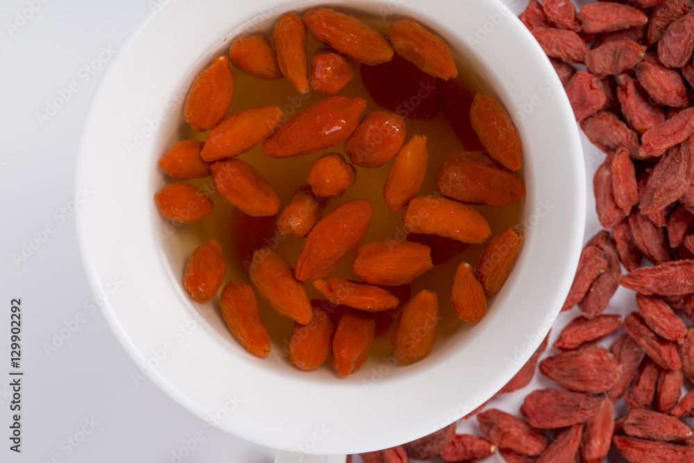 Chinese wolfberry (Goji) tea and wolfberry on the white background Chinese wolfberry (Goji) tea and wolfberry on the white background