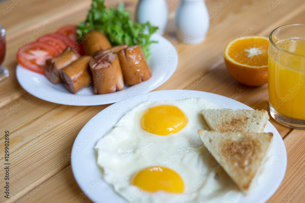 Orange juice, Two eggs and sausage for healthy breakfast. Orange juice, Two eggs and sausage for healthy breakfast.