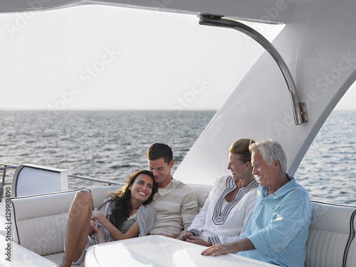 Happy young and middle aged couples relaxing on yacht © moodboard