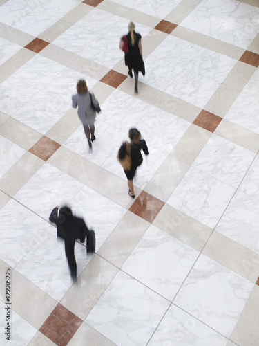 Photography Elevated view of blurred business people walking on tiled floor