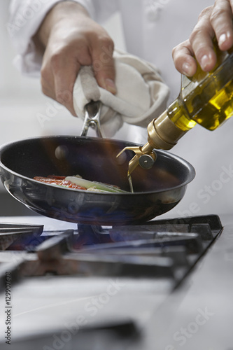 Closeup of a chef cooking food in frying pan