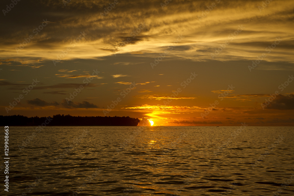 Sunset over Island Orange sky Water Clouds