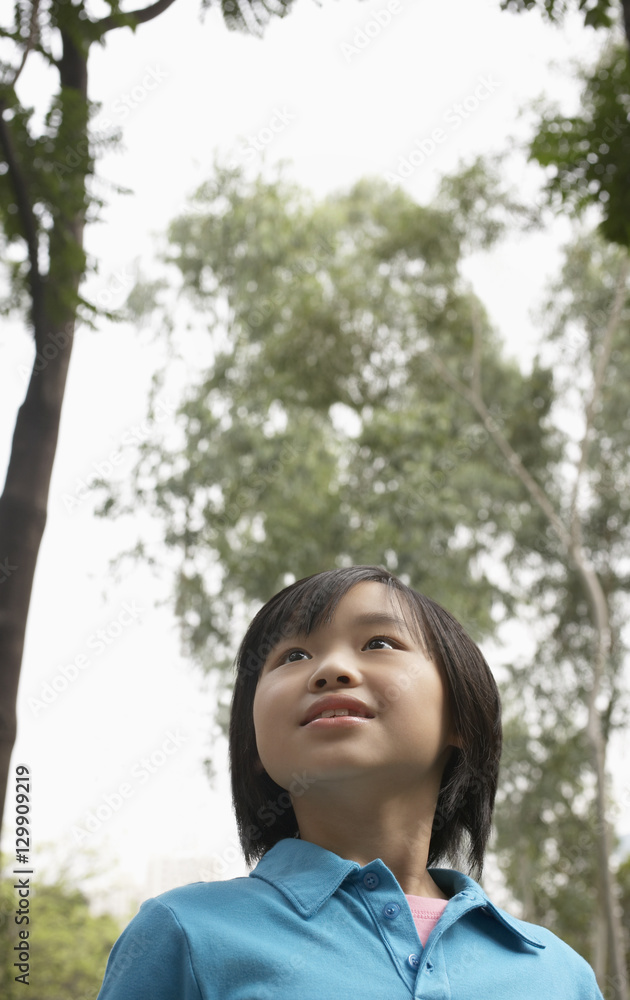 Closeup of cute young girl looking away in park Closeup of cute young girl looking away in park