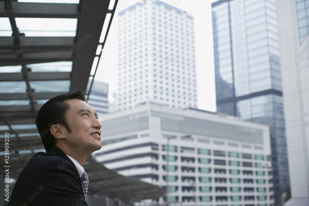 Side view of businessman looking at cityscape Side view of businessman looking at cityscape