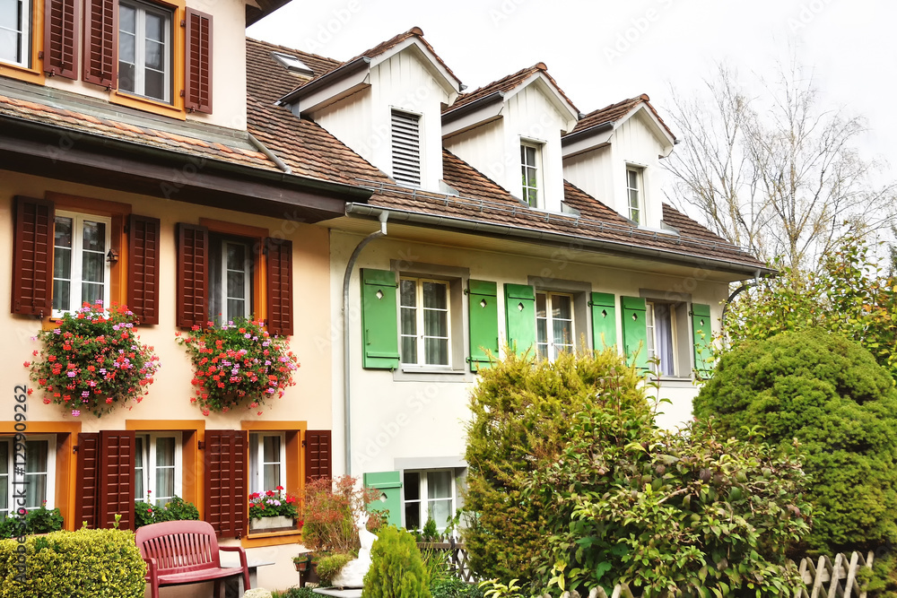 Characteristic houses with flowers at the windows in Bremgarten, Switzerland