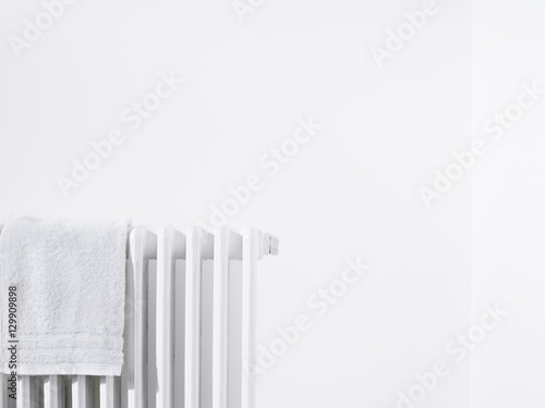 Towel on radiator and white wall