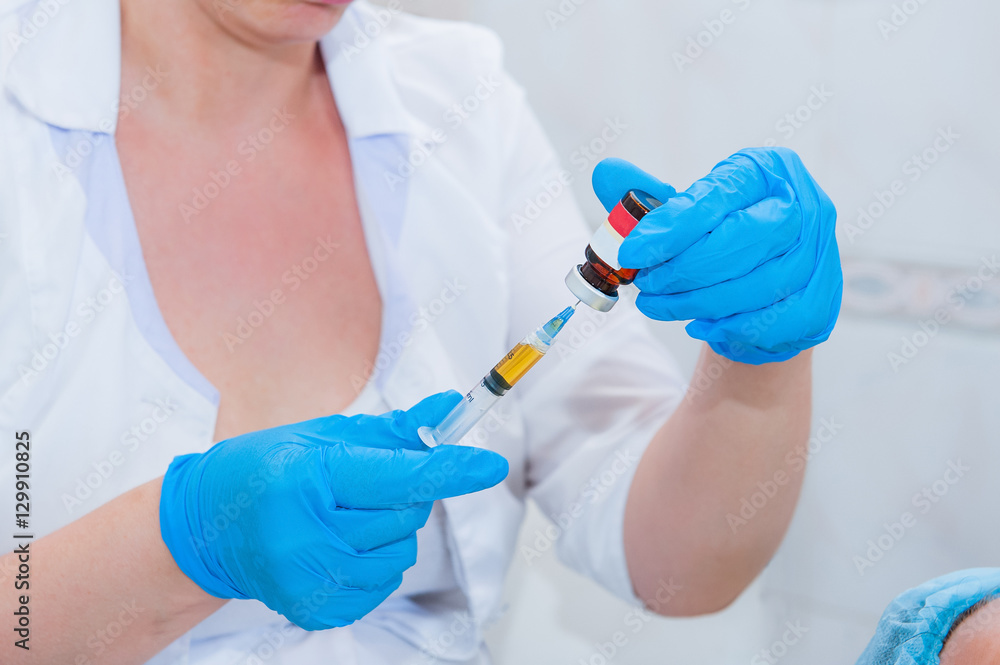 Cosmetic mesotherapy procedure - Syringe, medical injection in hand, palm or fingers. Medicine plastic vaccination equipment with needle. Cosmetic mesotherapy procedure - Syringe, medical injection in hand, palm or fingers. Medicine plastic vaccination equipment with needle.