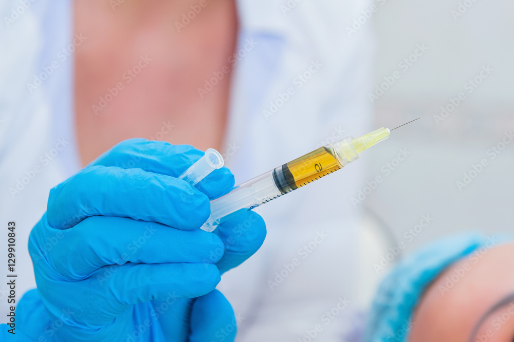 Cosmetic mesotherapy procedure - Syringe, medical injection in hand, palm or fingers. Medicine plastic vaccination equipment with needle. Cosmetic mesotherapy procedure - Syringe, medical injection in hand, palm or fingers. Medicine plastic vaccination equipment with needle.