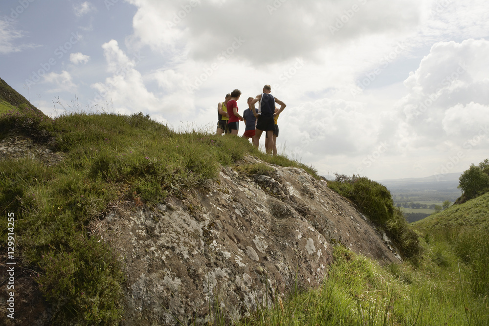 Low angle view of a group of hikers on hill