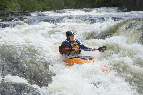 View of a man kayaking in rough river © moodboard