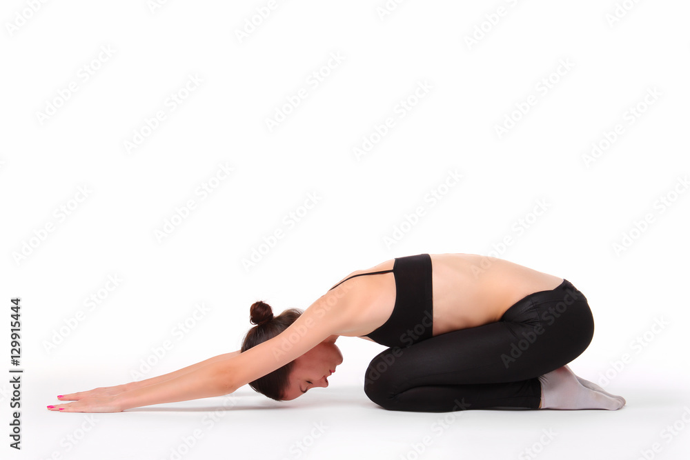 young beautiful yoga posing on a studio background