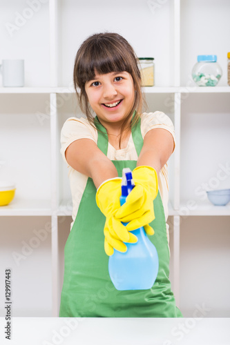 Happy little girl enjoys cleaning.
