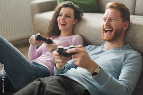 Beautiful couple playing video games on console