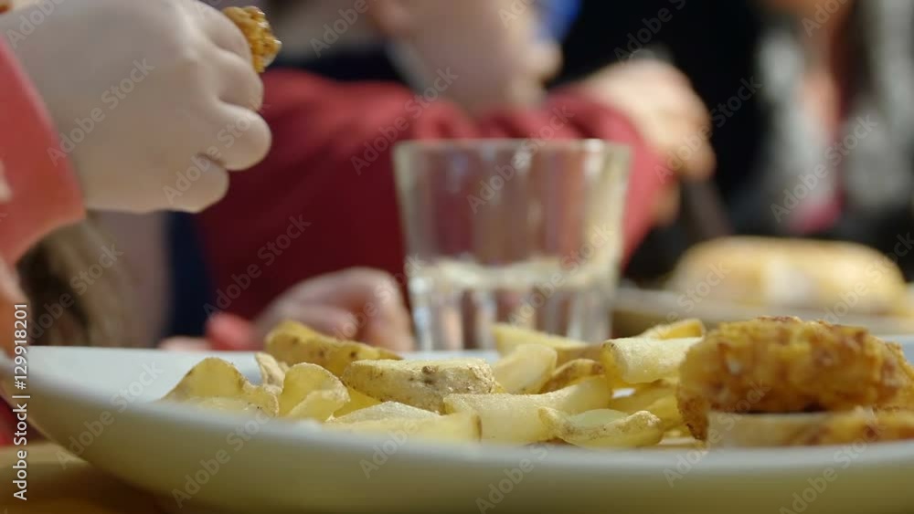 children eating in the fast food restaurant children eating in the fast food restaurant