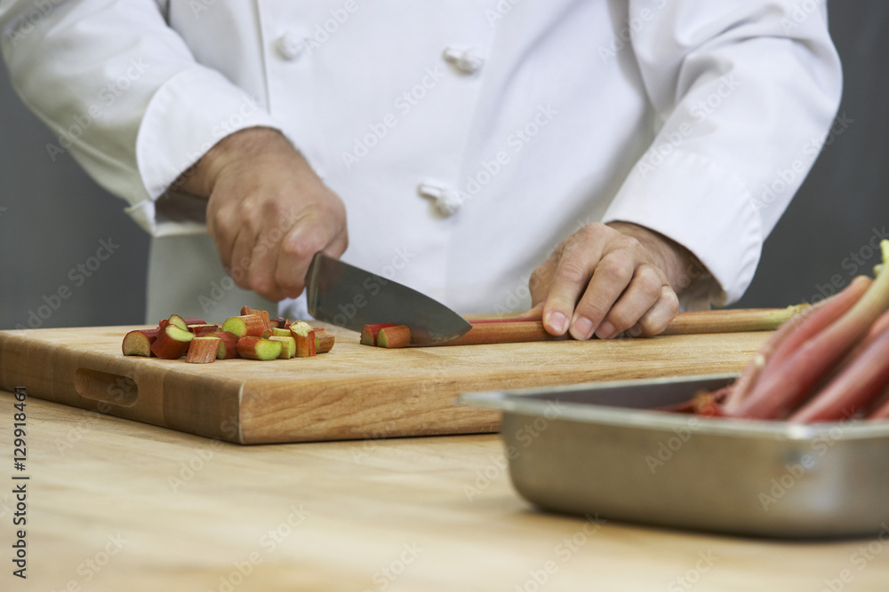 Closeup midsection of a chef chopping rhubarb Closeup midsection of a chef chopping rhubarb
