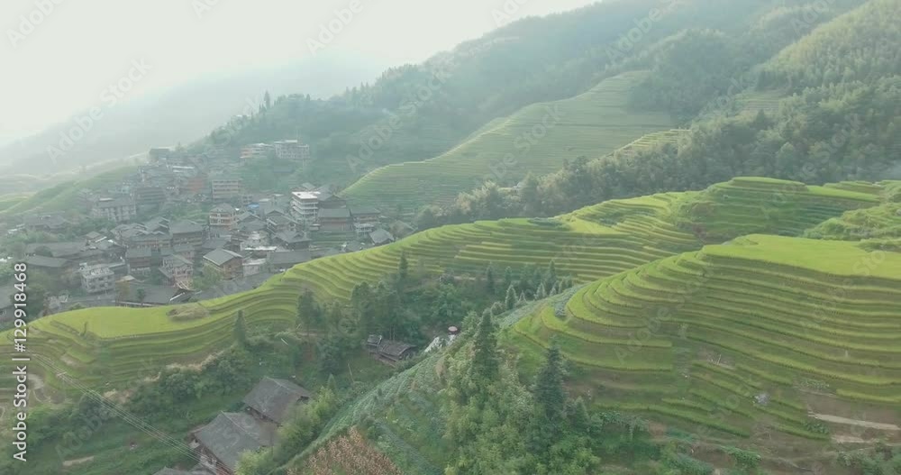 Beautiful 4k aerial sgot of the Longji Rice Terraces located next to the village of Ping'an in Longsheng County, Southern China. Fresh green rice fields in Fall. Mountain, rural landscape. Beautiful 4k aerial sgot of the Longji Rice Terraces located next to the village of Ping'an in Longsheng County, Southern China. Fresh green rice fields in Fall. Mountain, rural landscape.