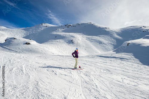 Snowboarder riding at French Alps mountain slopes