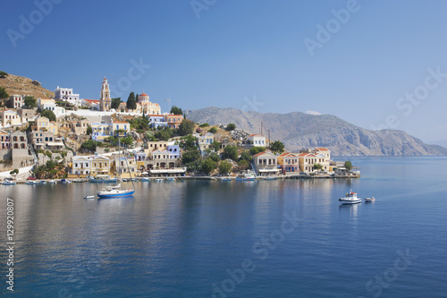 View across the tranquil waters of Harani Bay, Gialos (Yialos), Symi (Simi), Rhodes, Dodecanese Islands, South Aegean, Greece photo