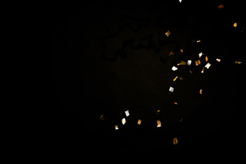 Golden confetti on black background