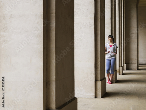 Full length of a young woman standing against column in portico © moodboard