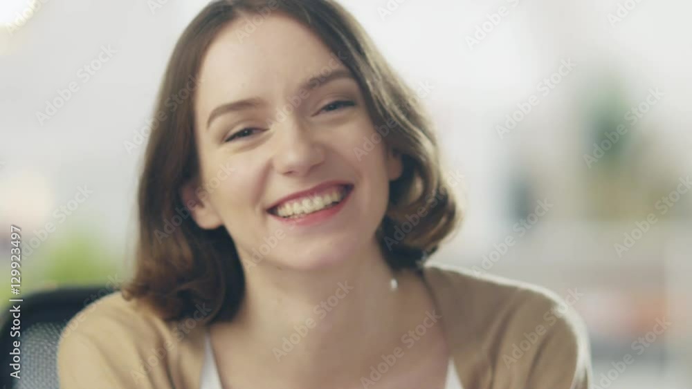 Beautiful Young Woman Laughs on the Camera. Her Background is Bright and Blurred. Shot on RED Cinema Camera in 4K (UHD). Beautiful Young Woman Laughs on the Camera. Her Background is Bright and Blurred. Shot on RED Cinema Camera in 4K (UHD).