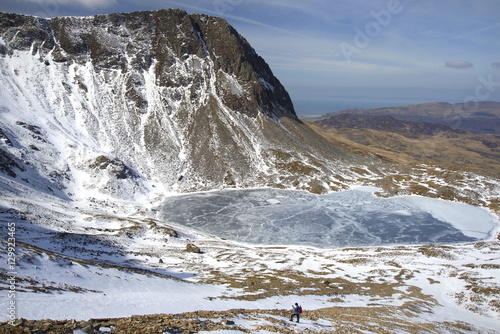 The frozen Llyn Y Gadair below summit of Cyfrwy, 811m, near Cadair Idris, Snowdonia National Park, Wales  photo