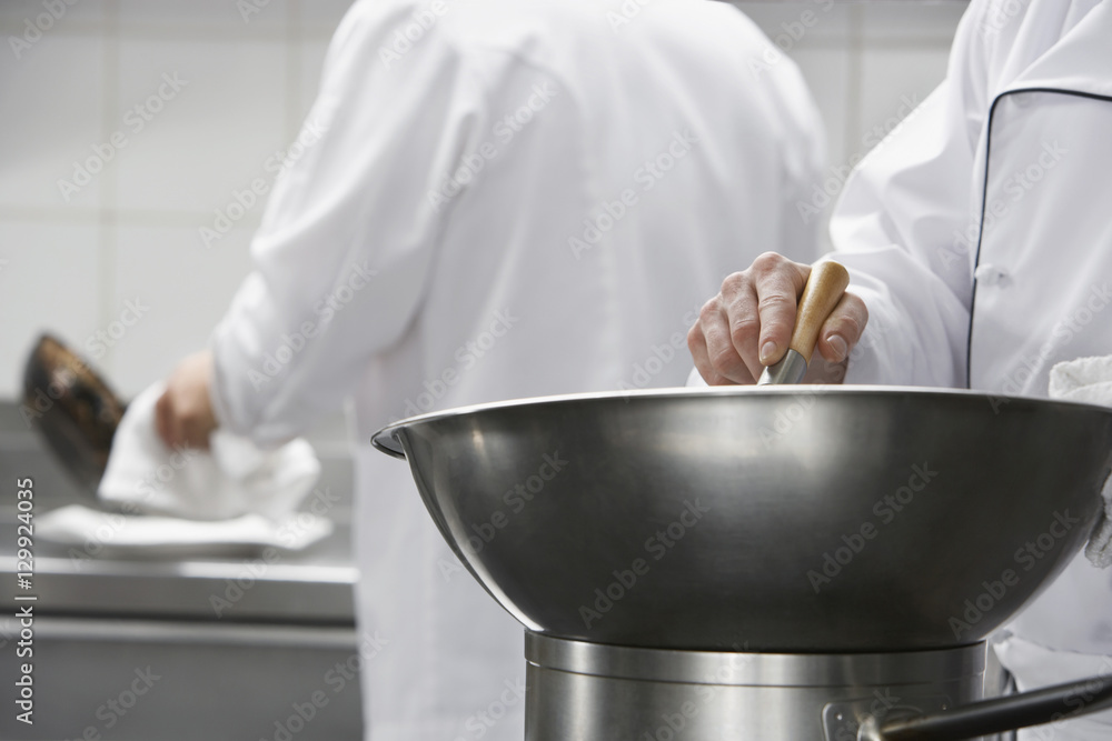 Closeup of a chef mixing ingredients in a bowl Closeup of a chef mixing ingredients in a bowl