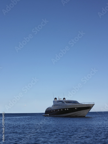 Yacht moored in sea against clear blue sky