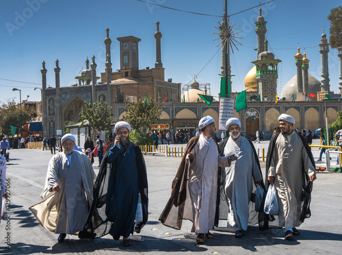 Chatting mullahs against the minarets of the Hazrat-e Masumeh (Holy Shrine), Qom, Iran photo