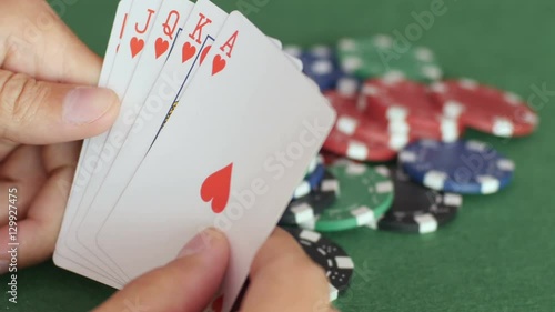 Male hands open royal flush and throw them on pile of casino chips, playing cards, victory, gambling. Close up, 4K Ultra HD.