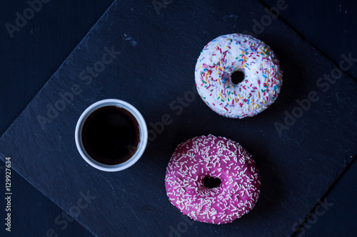 donuts and coffee on a black background photo