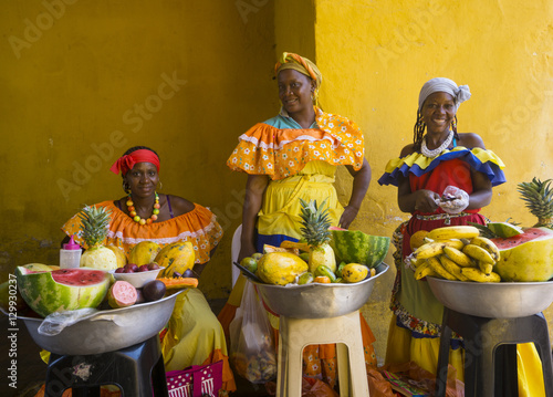 Women in traditional costume selling fruit in Cartagena, Colombia