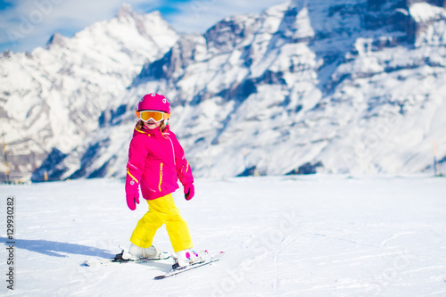 Ski and snow fun. Child in winter mountains.