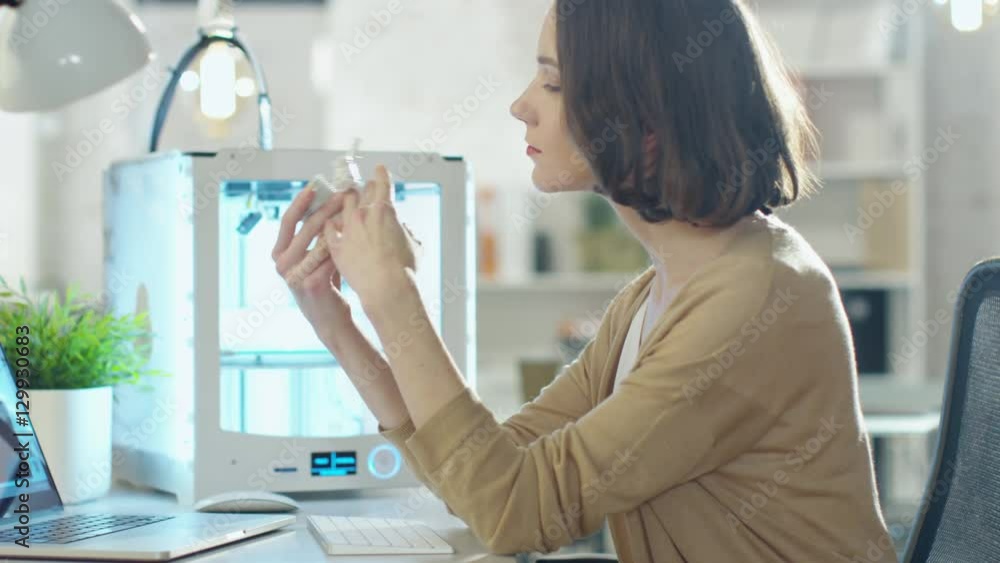 Young Woman Engineer Expects 3D Printed Part that She Just Made with Her 3D Printer. Shot on RED Cinema Camera in 4K (UHD). Young Woman Engineer Expects 3D Printed Part that She Just Made with Her 3D Printer. Shot on RED Cinema Camera in 4K (UHD).